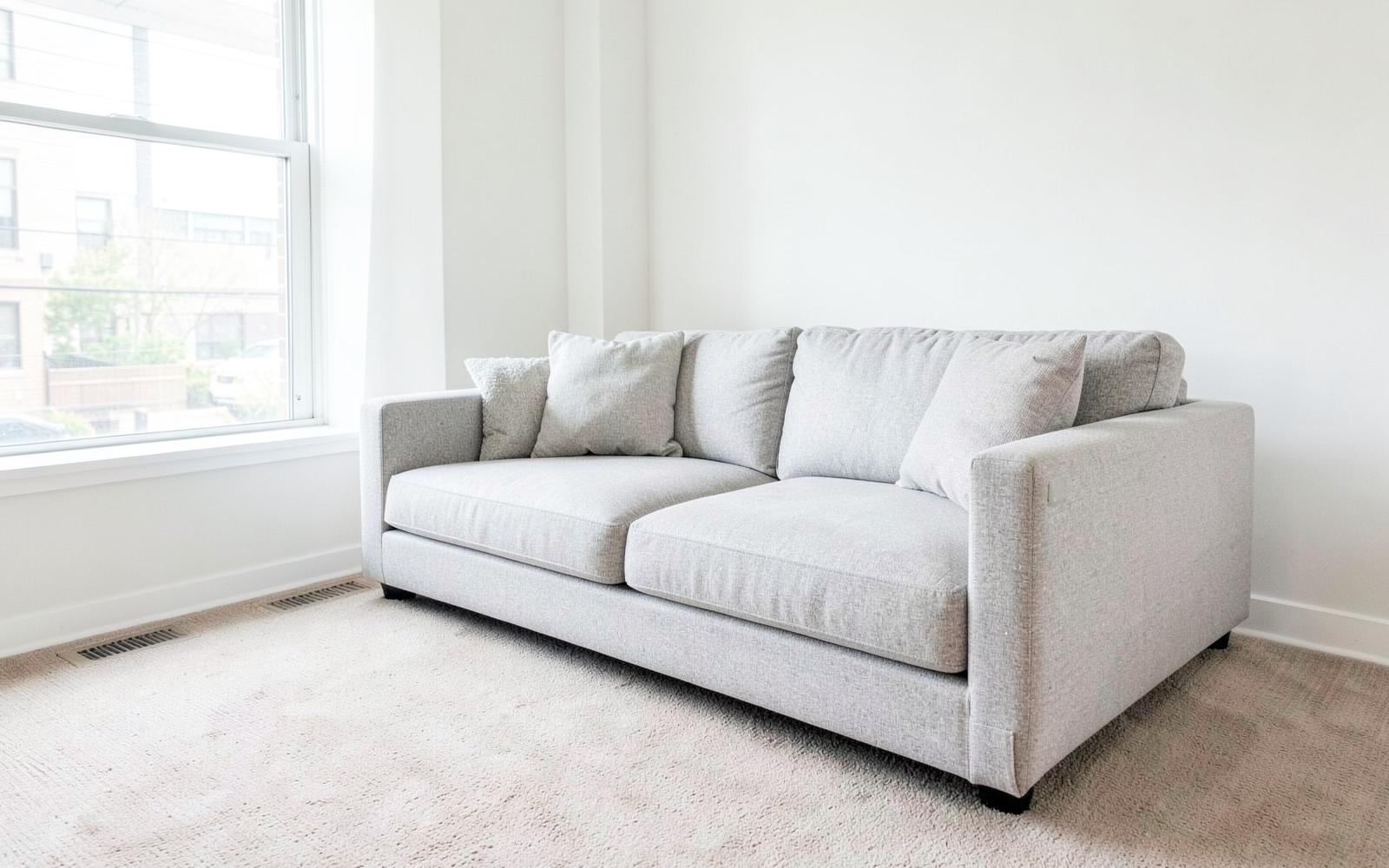 Clean grey fabric sofa and carpet in a bright Ottawa living room